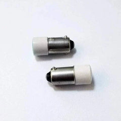 Two BA9S LED indicator bulbs with bayonet base and white caps on a white background