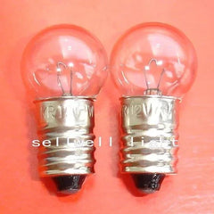 Two 12v 7w Krypton light bulbs with E10 G14 base on orange background