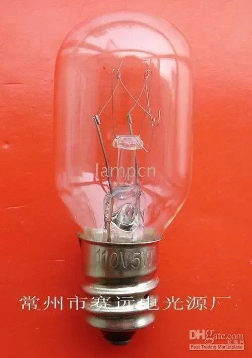 Miniature lamp E10 20x48 110V 5W A118 Sellwell Lighting bulb close-up on red background