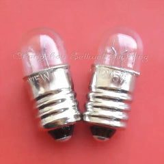 Two miniature 12v 5w E10 base light bulbs with clear glass tops on a red background
