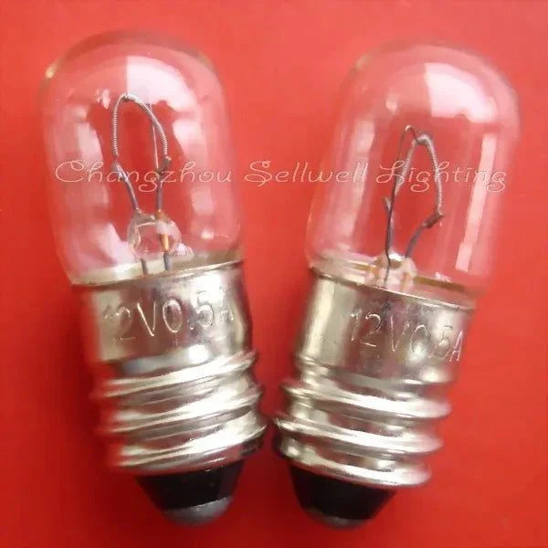 Close-up of 10pcs miniature light bulbs 12v 0.5a E10 T10x27 A307 with clear glass and metal base on red background