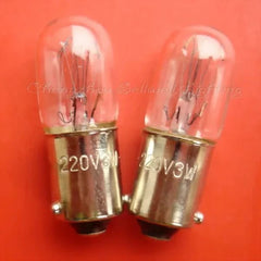Two miniature 220V 3W ba9s base light bulbs on orange background