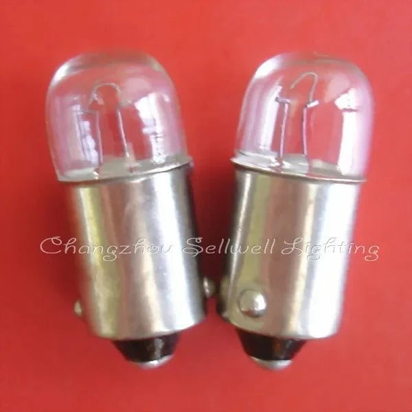 Miniature 12v 2w BA9S base light bulbs with clear glass casing on red background