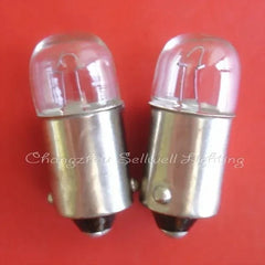 Miniature 12v 2w BA9S base light bulbs with clear glass casing on red background