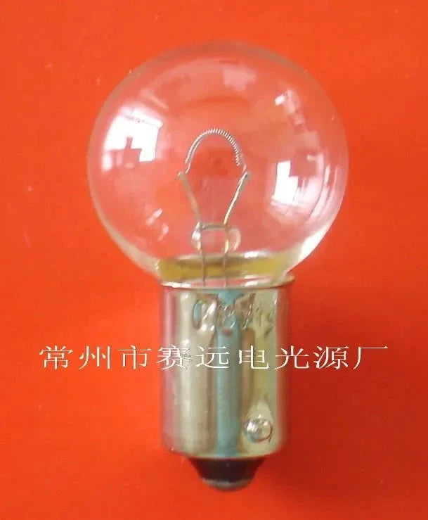 Miniaturre light 8v 12w ba9s A231 small bulb with clear glass and metal base against orange background