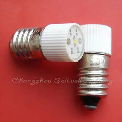 6.3V E10 base red LED lamp bulb close-up on red background