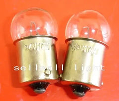24V 10W Ba15s miniature light bulbs with clear glass casing on a red background