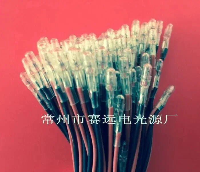 bundle of 12V 60mA miniature electric light source bulbs with wiring on red background