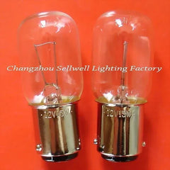 Two 12V 15W BA15d miniature lamps with clear glass bulbs and metal bases on an orange background