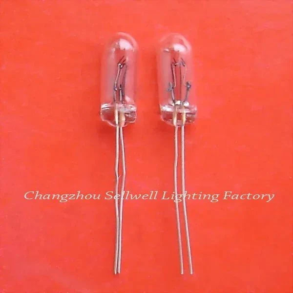 Two miniature 24v 50ma clear glass lamps with wire leads on orange background