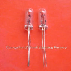 Two miniature 24v 50ma clear glass lamps with wire leads on orange background