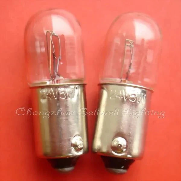 Close-up of two 24V 5W miniature lamps with BA9s base on an orange background