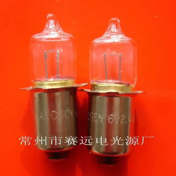 Close-up of two 6V 2.4W P13.5S halogen bulbs lamp on red background