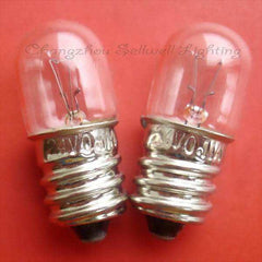 Two small E12 instrument bulbs with clear glass and metal screw bases on a red background