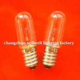 Two E14 transparent spiral old screw indicator bulbs on orange background