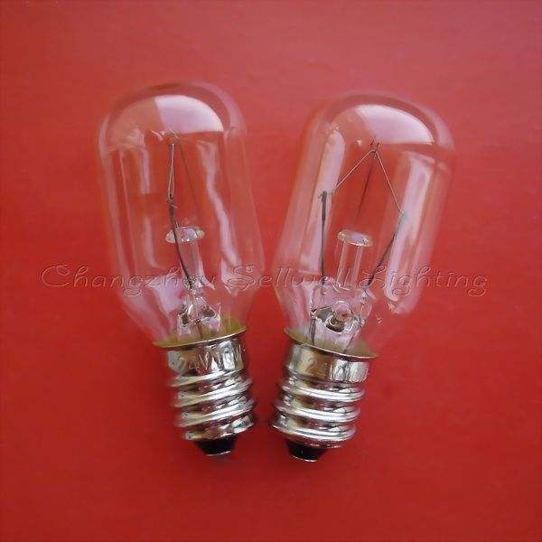 Pair of E12 screw base small instrument indicator bulbs on red background