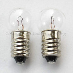 Two small E10 screw base instrument bulbs with clear glass tops and metal threaded bases for low voltage applications.
