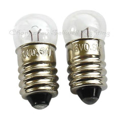 Two small E10 instruments bulb screws with clear glass tops and metallic bases for various voltage applications