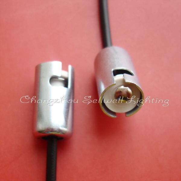 Close-up of two silver Ba9s lamp holders with wires on a red background for educational use
