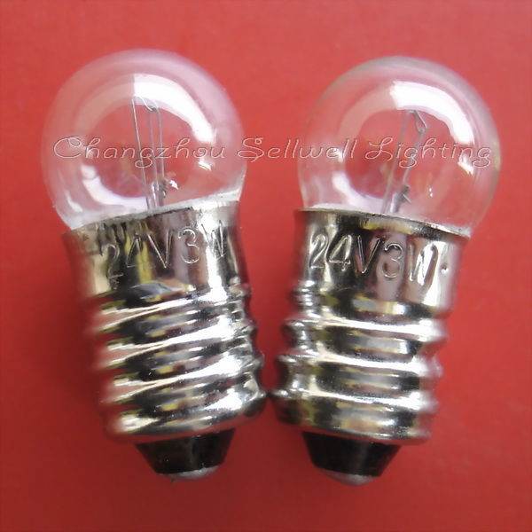Close-up of two instruments bulb screw E10 lamp holders with 24V 3W markings on a red background