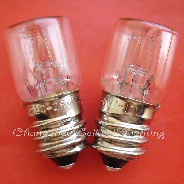 Two E14 transparent spiral indicator light bulbs with old screw base on red background