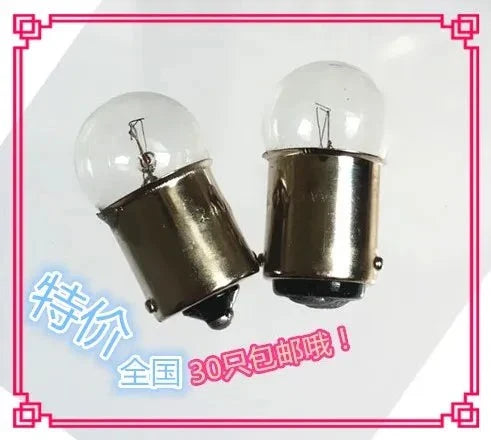 Two small bayonet B15 indicator light bulbs with clear glass and metal bases for 6V-48V use