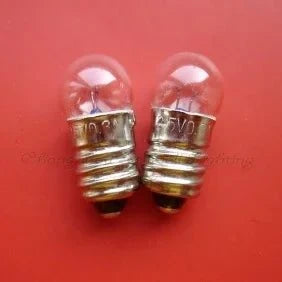 Two miniature 2.5v 0.3a E10 base light bulbs on red background