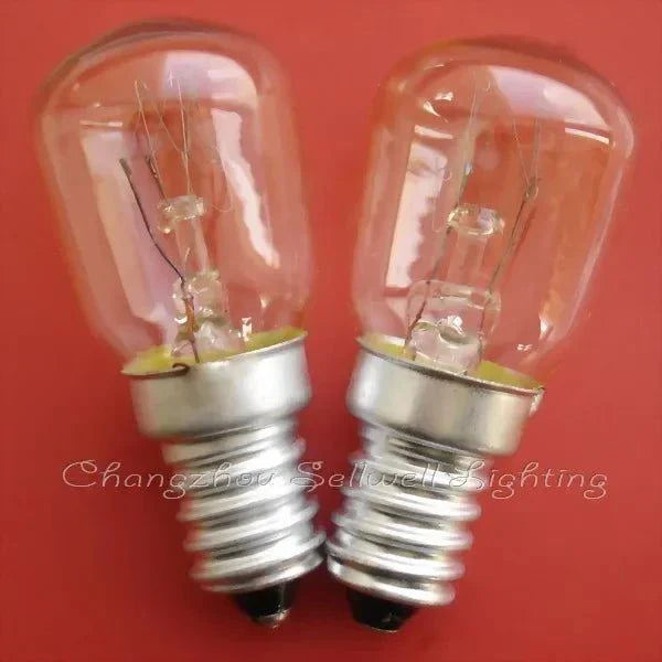 Two miniature 220v 15w E14S light bulbs with clear glass and silver screw bases on a red background