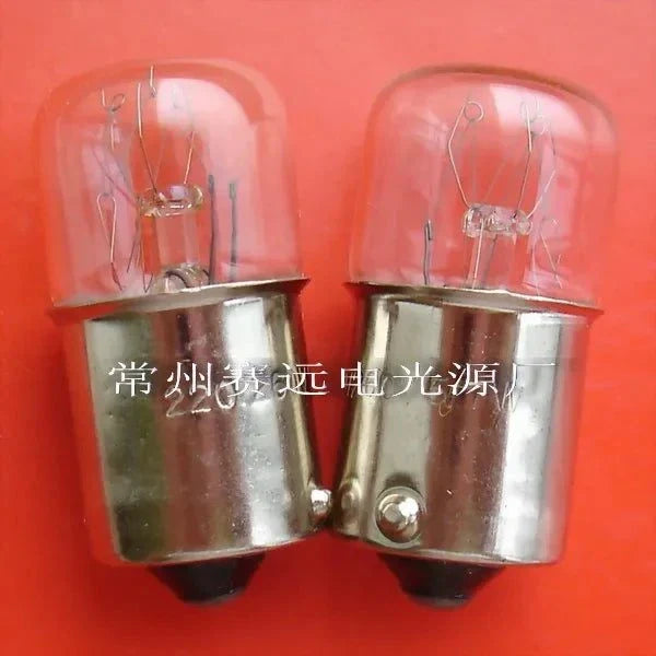 Pair of miniature light ba15s bulbs 220v 5/7w with glass tops and metal bases on orange background