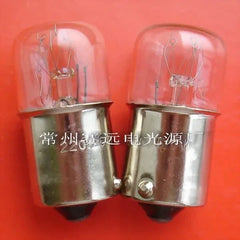 Pair of miniature light ba15s bulbs 220v 5/7w with glass tops and metal bases on orange background
