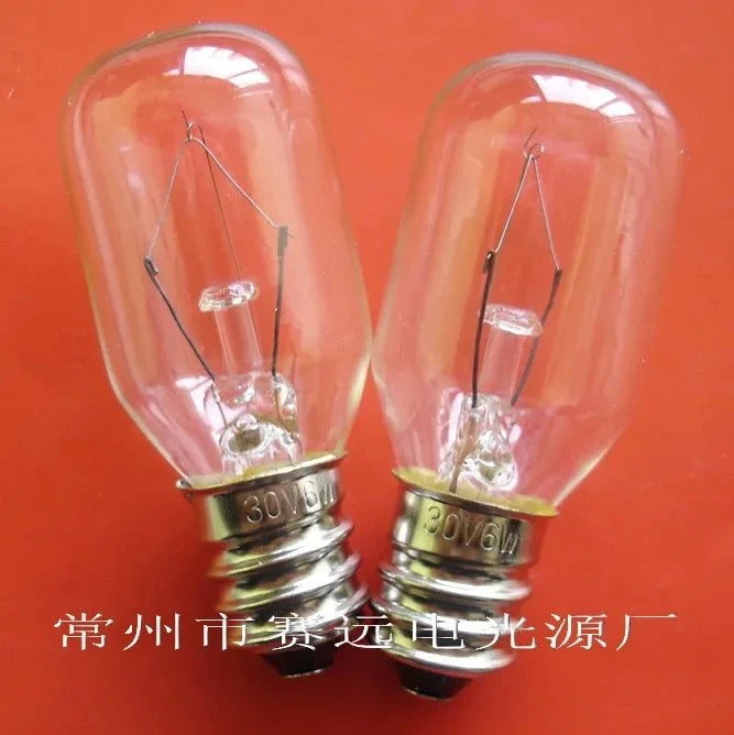 Two miniature 30v 6w E12 base light bulbs on orange background