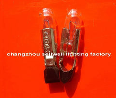 Close-up of two 24V 50MA T5.5KX22 telephone bulbs with metal bases on an orange background