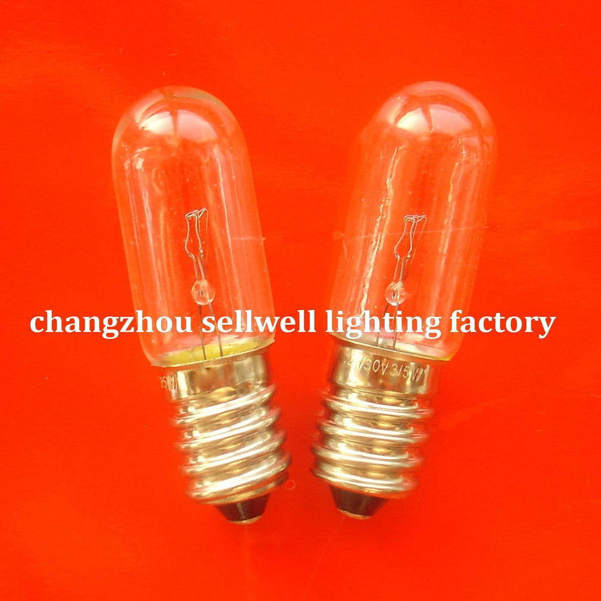 Two E14 transparent spiral old screw indicator bulbs on orange background